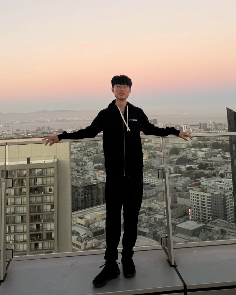 Ian Lin standing on a rooftop at sunset
